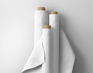 Three large blank white empty plain fabric bolts standing against white isolated background