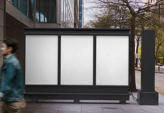 Three blank white empty vertical outdoor posters are displayed on the advertising public panel.  