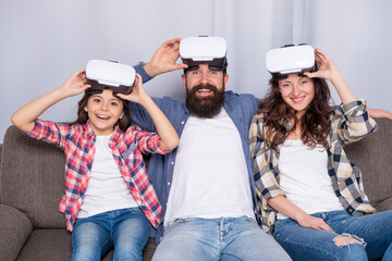 happy parents with kid girl use modern technology at home. mom dad and daughter.