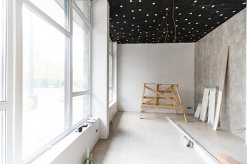 renovated room with shopping window - empty store shop with wooden floor and white walls