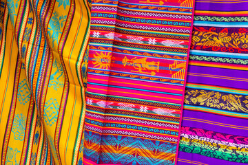 Colorful Andean fabric textiles on the local souvenir market in Otavalo, Ecuador. South America.