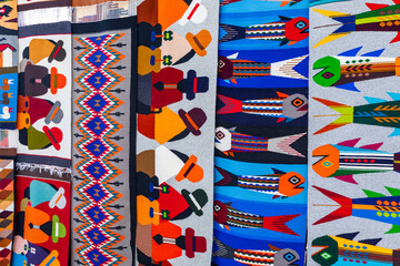 Colorful Andean fabric textiles on the local souvenir market in Otavalo, Ecuador. South America. - obrazy, fototapety, plakaty