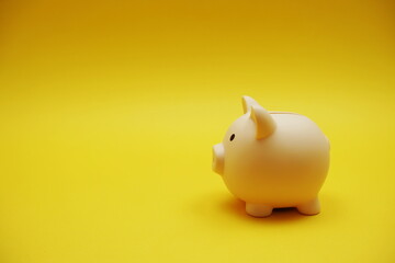 Piggy banks saving with space copy on yellow background