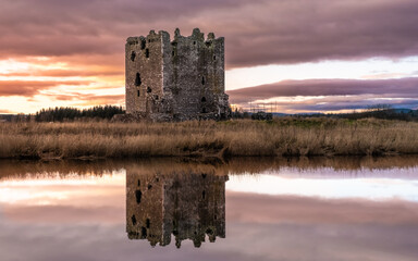 Winter sunset over Threave Castle, reflecting on the River Dee, Scotland