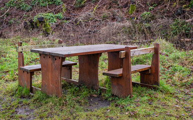 Close up of a wooden picnic table with wheelchair and disabled access