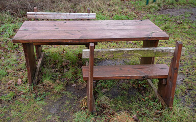 Close up of a wooden picnic table with space for wheelchair and disabled access