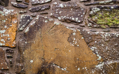 Abstract of an old Scottish castle stone wall, with moss growing