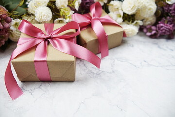 Gift boxes and flower bouquet with space copy on marble background