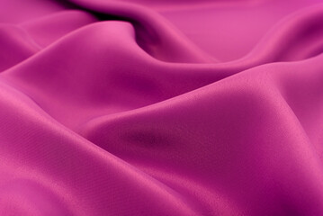 Fabric of purple cloth. Fabric texture for background and design works of art, beautiful wrinkled pattern of silk or linen. A crumpled piece of cloth