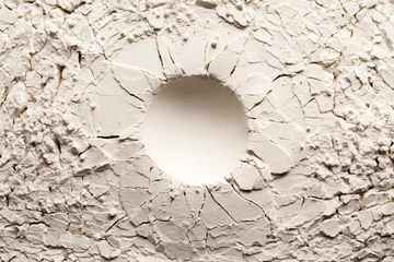 Foto op Canvas Round crater on white backgroung with crack. Cracked background with a round hole. © Azazello