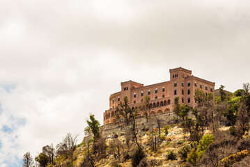 Fototapeta na wymiar View of the Castello Utveggio on the hill of Pellegrino, mount on a clear sunny day. Palermo, Sicily.