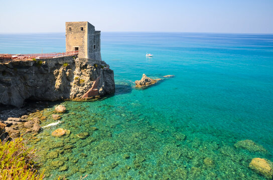Torre delle Ciavole, a medieval guard watchtower on the rocky northern Sicilian coast with crystal clear sea water near Gliaca di Piraino, between Brolo and Gioiosa Marea.
