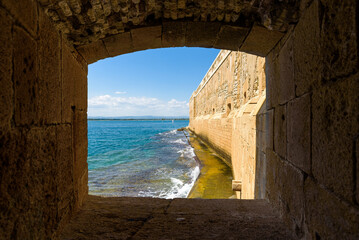 The Maniace Castle in the island of Ortigia. It was built during the Swabian period by Emperor Frederick II of Swabia. It features a decorated portal, arches, towers, a banquet room and a lighthouse.
