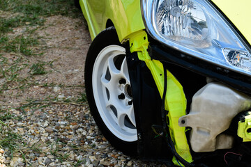 A car's grille slipped off the hood panel, revealing the front engine clearly, soft and selective focus, car accident and car insurance concept.