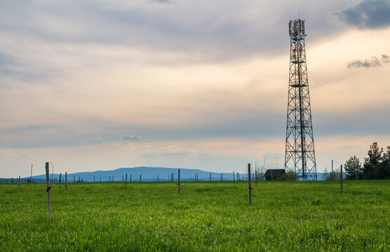 Mobile transmitter tower on spring meadow with sunset cloud sky. Czech landscape - Powered by Adobe