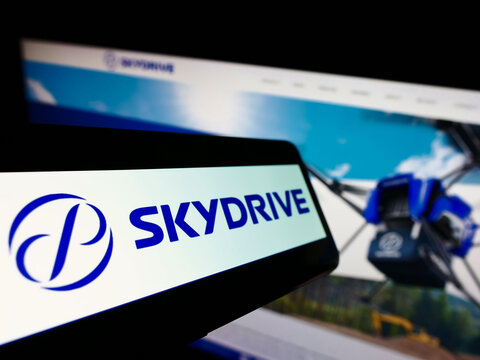 Stuttgart, Germany - 03-29-2022: Mobile phone with logo of Japanese aviation company SkyDrive Inc. on screen in front of business website. Focus on center-left of phone display.