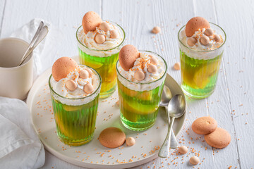 Fresh green jelly as a summer dessert with cream.