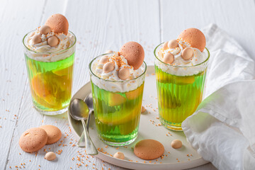 Homemade green jelly with whipped cream and nectarines .