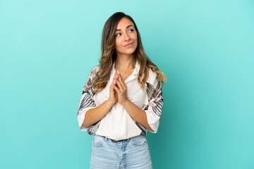 Young woman over isolated blue background scheming something