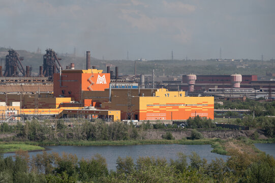 Orange factory building with logo of MMK