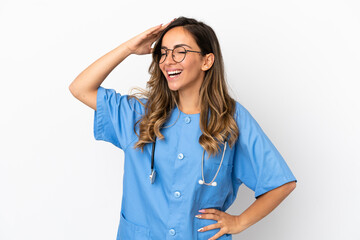 Young surgeon doctor woman over isolated white wall has realized something and intending the solution