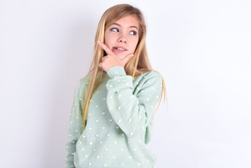 little caucasian kid girl wearing fashion sweater over blue background Thinking worried about a...