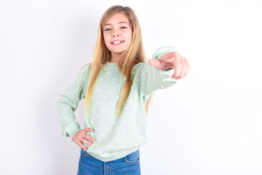 Little Caucasian Kid Girl Wearing Fashion Sweater Over Blue Background Pointing At Camera With A Satisfied, Confident, Friendly Smile, Choosing You