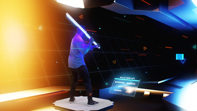 An african american man wearing a virtual reality helmet with shining sword in the cyberspace of the virtual world plays a video holographic game, by breaking 3D cubes that are move to him.