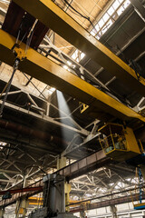 The interior of an old manufacturing plant. Large hangar in a factory with many special machines and technological equipment without people