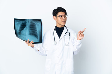 Young Chinese doctor man holding radiography isolated on white background pointing up a great idea