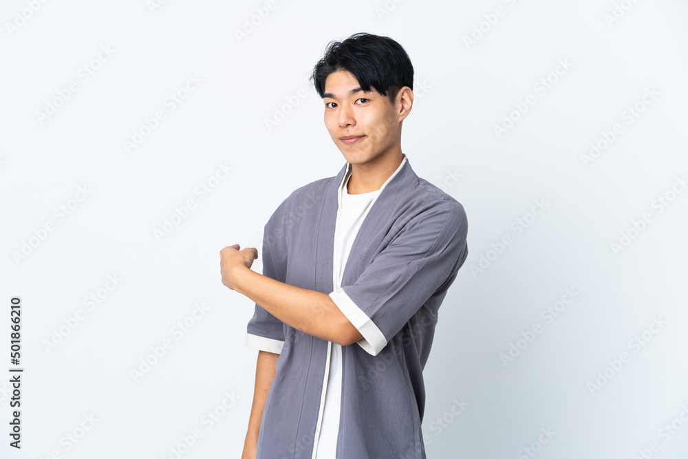 Poster Young Chinese man isolated on white background pointing back