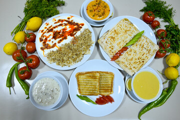 Table scene of assorted take out or delivery foods. Pizza, hamburgers, Doner, fried chicken and sides. Top down view on a table.
