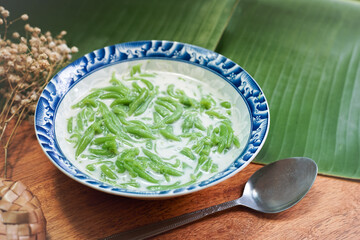 Lod Chong, Thai dessert, Lod Chong with coconut milk on a wooden floor. - obrazy, fototapety, plakaty