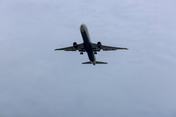 Fototapeta na wymiar An aircraft on final approach for landing view over sky