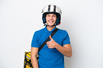 Young caucasian man with thermal backpack isolated on white background giving a thumbs up gesture