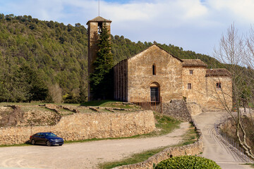 Sant Esteve Church in the municipality of Oliana in SolsonÃ©s with a parked vehicle