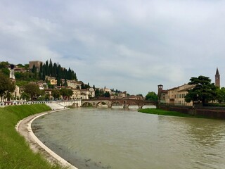 Fototapeta na wymiar Verona, Italy. Ponte Pietra bridge, a historical Roman arch bridge, across the Adige river.