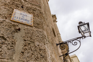 Old Havana, Cuba, Square of the Cathedral of the Virgin Mary street sign. Plaza de La Catedral de...