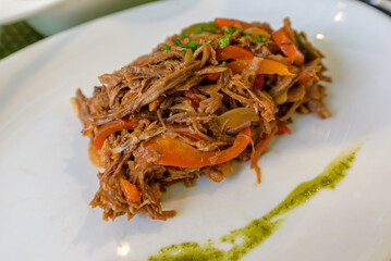 Ropa vieja, traditional Cuban national dish made of shredded beef and vegetables with tomato based sauce, peppers and onions served in a restaurant in Old Havana
