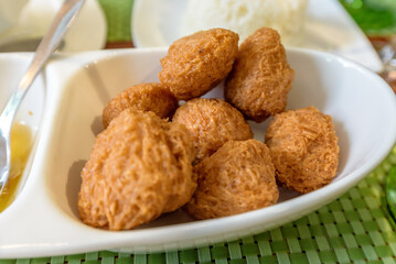 Fritura de Malanga (Fried Taro), traditional Cuban dish served with honey in a restaurant in Havana, Cuba.
