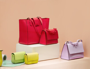 Colorful female bags on a showcase. Glamour woman's bags