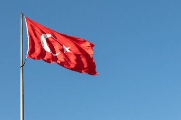 Naklejka na ściany i meble blue sky and Turkish flag waving in the wind