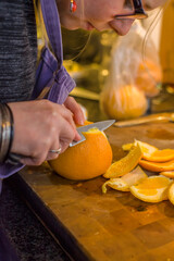 Woman skinning orange
