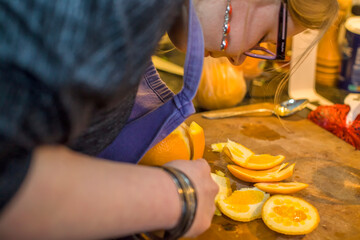 Woman skinning orange