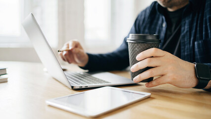 Work with finance accountant. Workplace a man uses a laptop report in the company electronic documents.