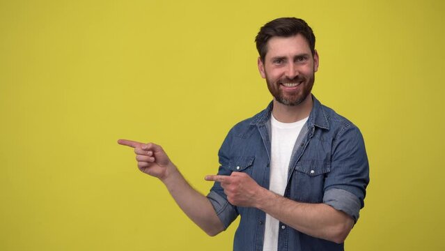 Handsome man nods approvingly and pointing to the side with his hands showing his approval