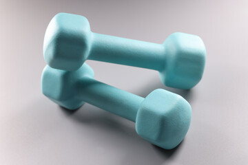 Blue dumbbells on grey background, planning weight loss, equipment for sport activity