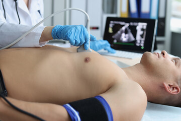 Doctor doing ultrasound of rib cage, cardiologist examining a patients heart