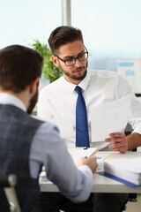 Coworkers men working at financial papers, solve and discuss problems