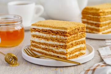 Honey cake on a white plate. Delicious healthy dessert. selective focus